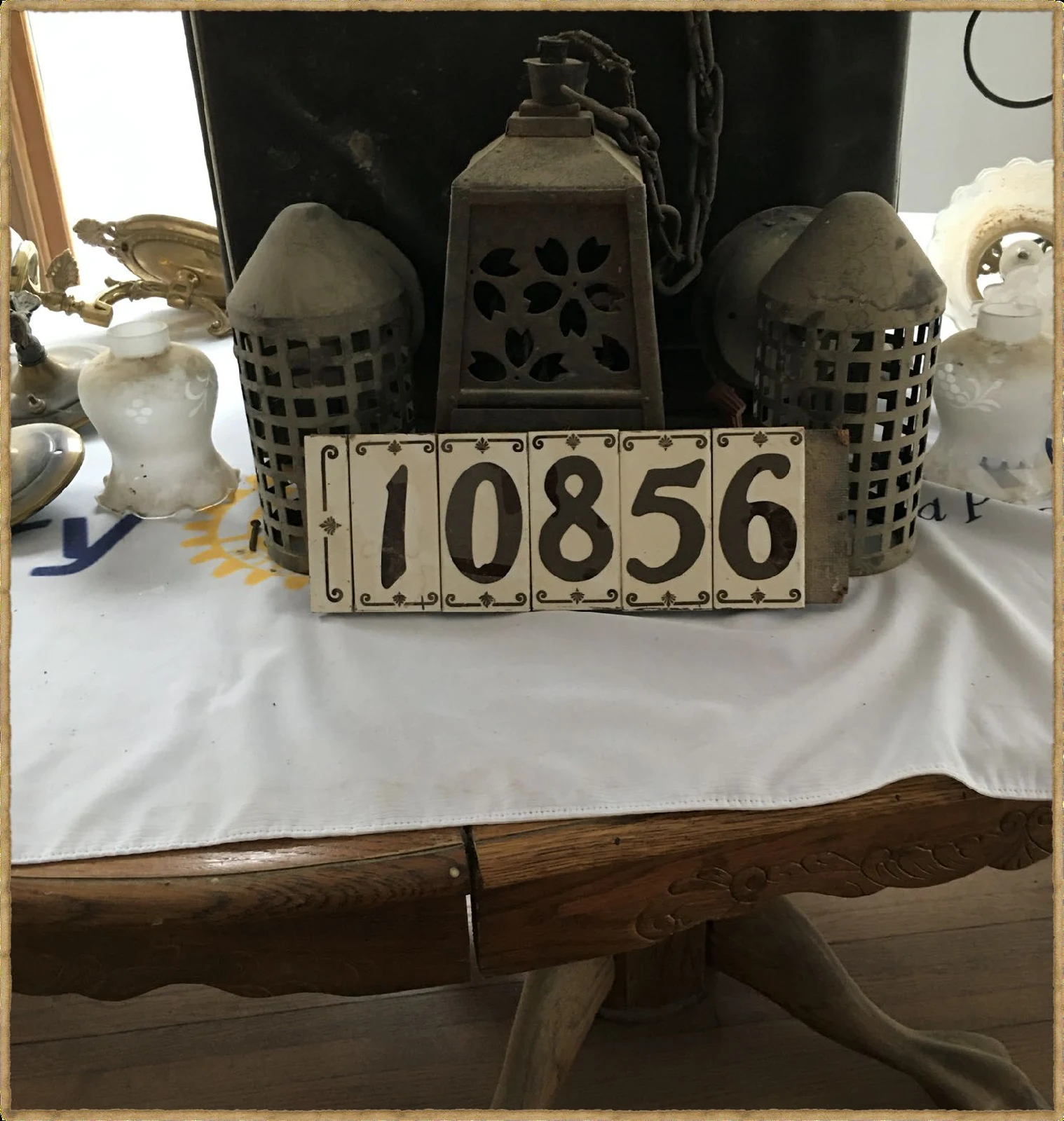 Historic House Number and Lantern Fixture Historic 10856 house-number plate displayed with period lighting fixtures.