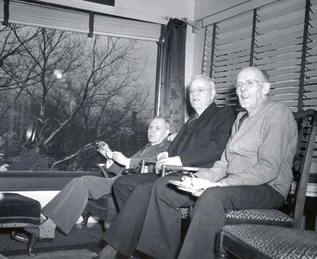 Historic Sun Porch Gathering Historic photograph of people seated together on the sun porch.