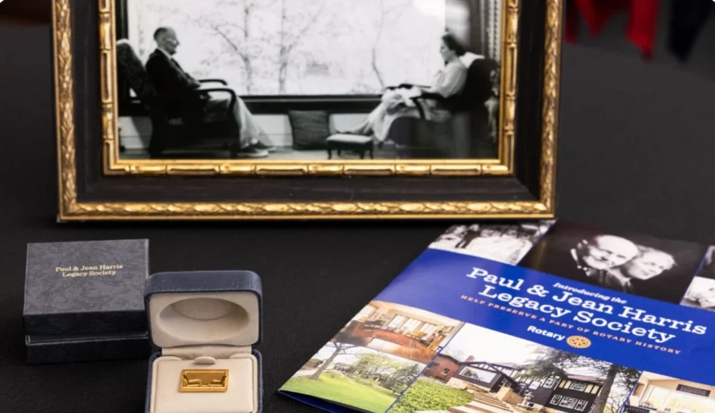Legacy Society Recognition Items Display of a presentation pin, box, brochure, and framed historic photograph.