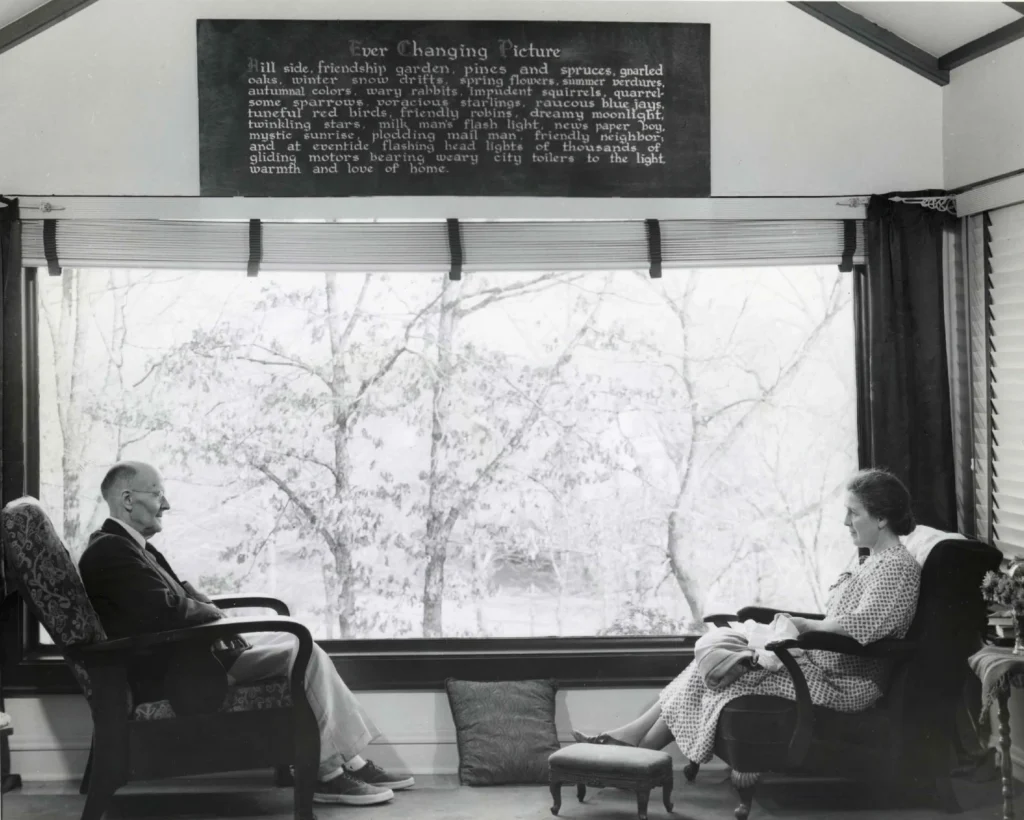Paul and Jean Harris on the Front Sun Porch Paul and Jean Harris seated across from one another on the front sun porch.