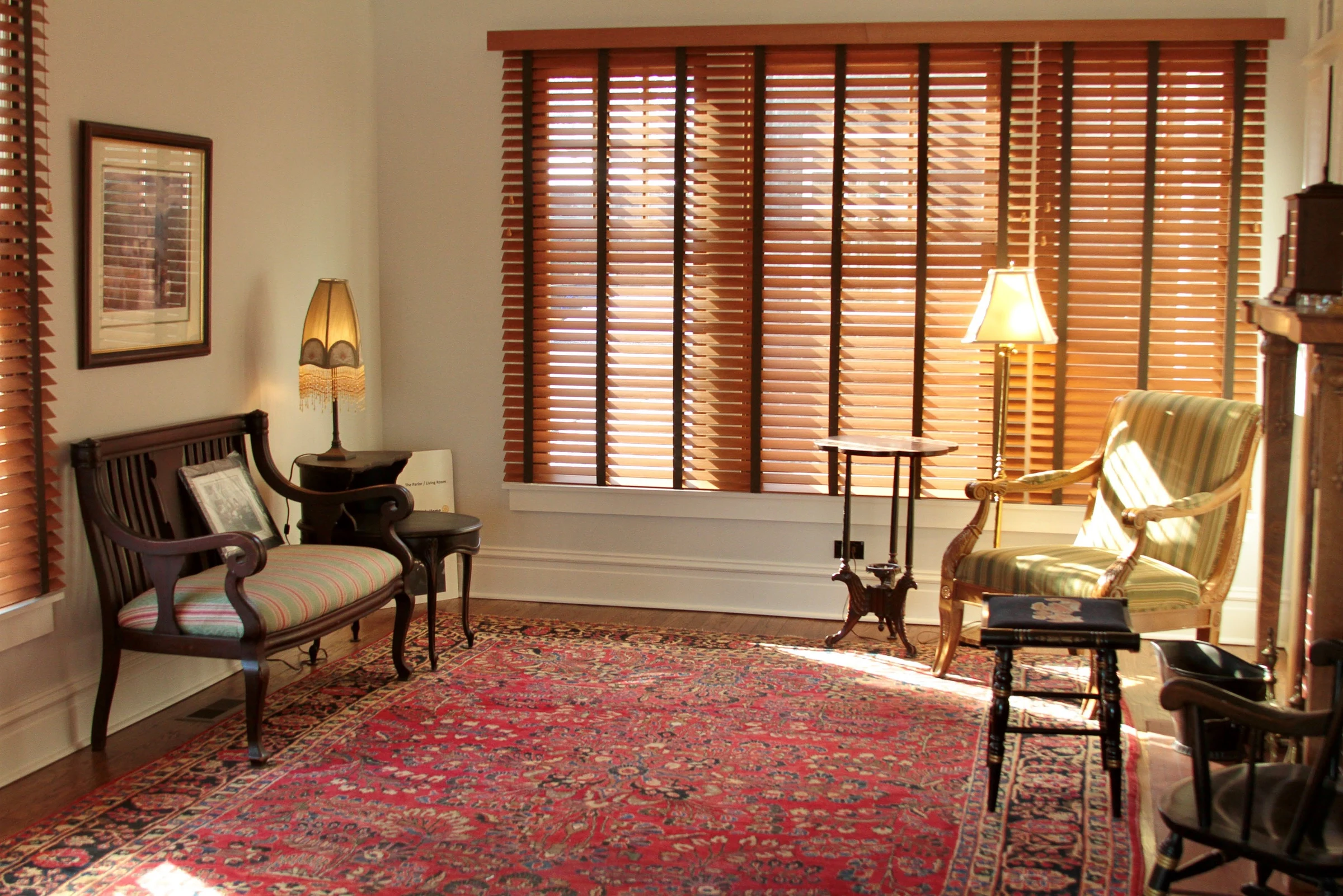 Restored Sitting Room Restored sitting room with period furniture, wood blinds, and an area rug.