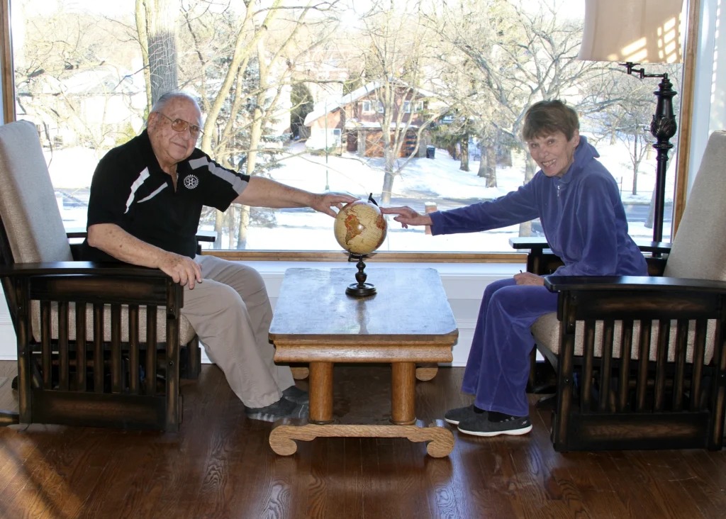 Visitors on the Front Sun Porch – 2022 Two visitors seated across from one another on the front sun porch.